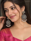 Woman wearing oxidised silver chandbali earrings with pearl drops and pink silk saree blouse