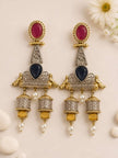 Front flat-lay of dual-tone oxidised jhumka earrings on cream background with daisies showing full earring detail