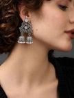 Model wearing oxidised silver double jhumka earring with filigree lotus top panel and twin bell drops
