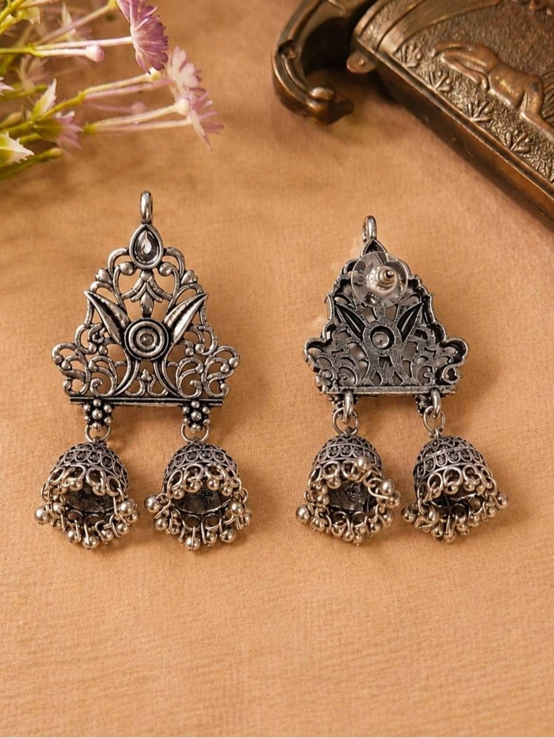 Front and back view of oxidised silver double jhumka earrings showing push-back stud closure on reverse