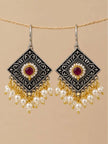 Pair of oxidised silver diamond-shaped earrings with pearl drops hanging from rope against beige background