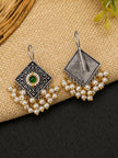 Front and back view of oxidised silver diamond earrings with pearl drops laid on natural jute fabric