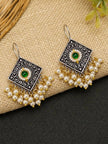 Pair of oxidised silver diamond earrings with green cabochon and pearl fringe displayed on jute surface