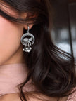 Oxidised silver elephant crescent earring with ghungroo drops worn on a woman's ear
