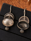 Front and back view of oxidised silver dome jhumka earrings showing hollow interior on black display tray