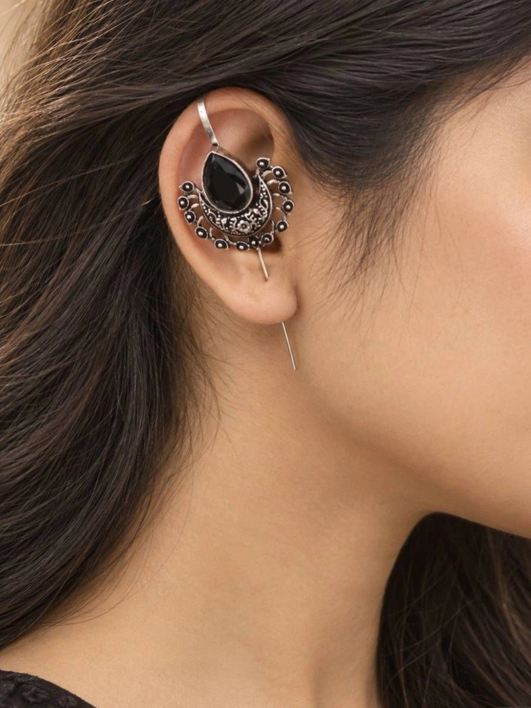 Close-up of oxidised silver ear cuff earring worn on a woman's ear showing fit and scale