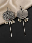 Front and back view of oxidised silver floral ear cuff earrings with pearl drops and red stone on dark background