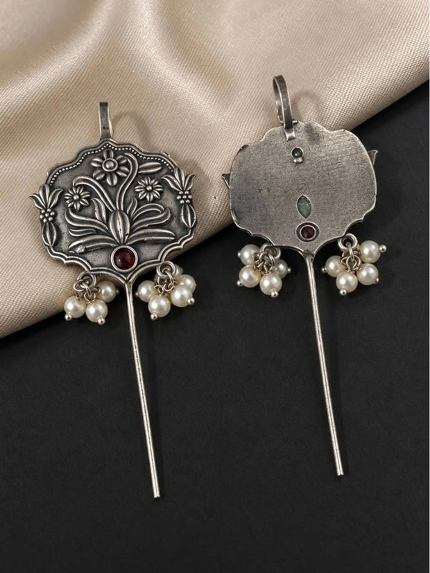 Front and back view of oxidised silver floral ear cuff earrings with pearl drops and red stone on dark background