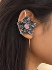 Oxidised silver floral ear cuff earring worn on a woman's ear showing fit and scale
