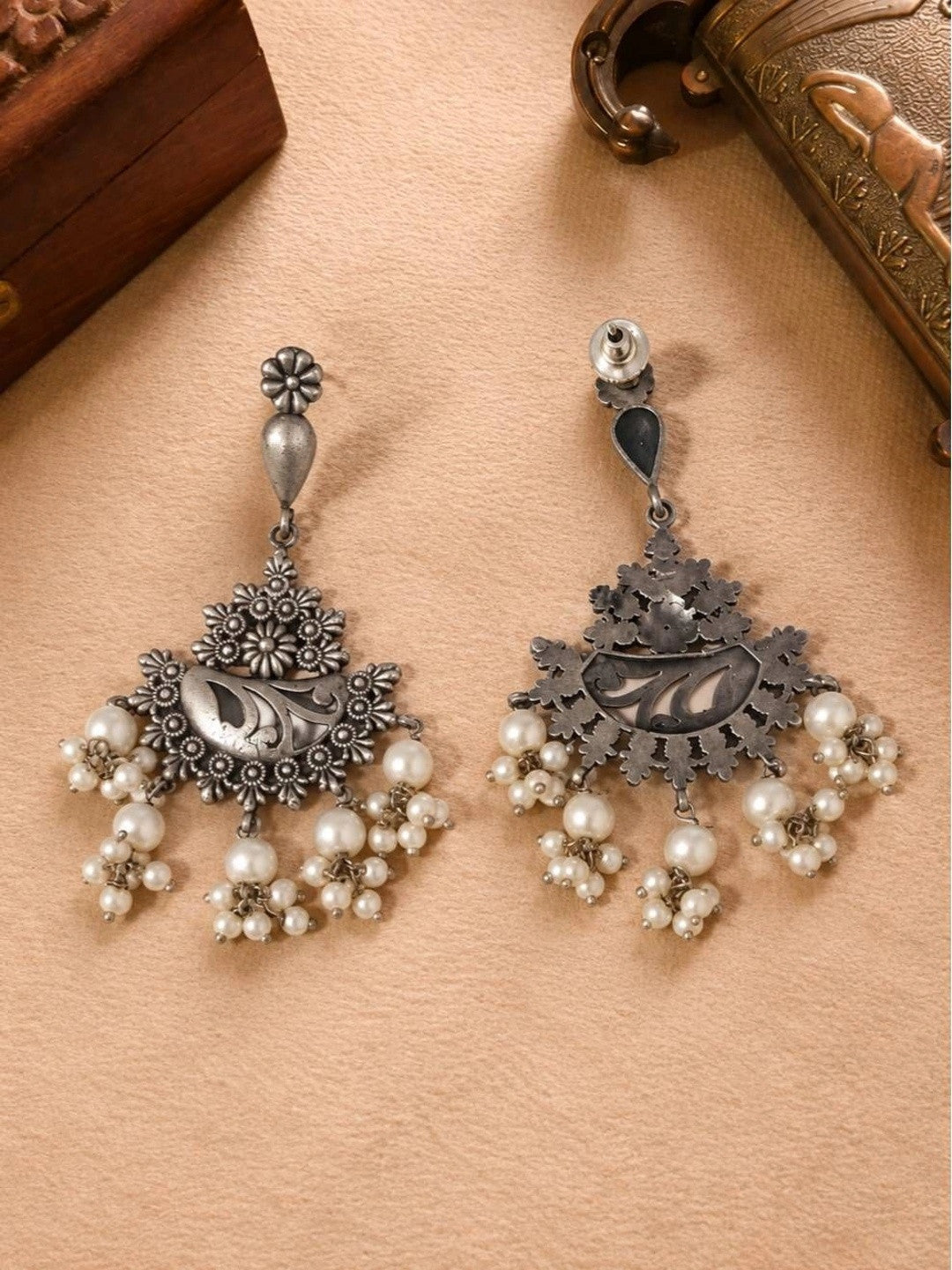Front and back view of oxidised silver chandbali earrings showing engraved crescent panel and pearl drop fringe