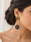 Woman wearing oxidised silver geometric drop earring with yellow stud and red green enamel hexagonal pendant
