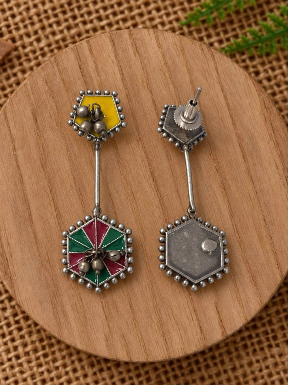 Front and back view of geometric enamel earrings showing screw-back closure and plain silver reverse side