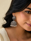 Woman wearing large oxidised silver jhumka earring with pearl drops and lotus stud top
