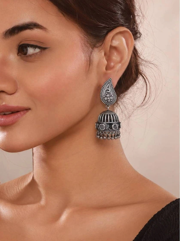 Woman wearing oxidised silver birdcage jhumka with paisley stud top and ghungroo bead fringe