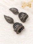 Pair of oxidised silver birdcage jhumka earrings with bird motifs placed on white fur surface