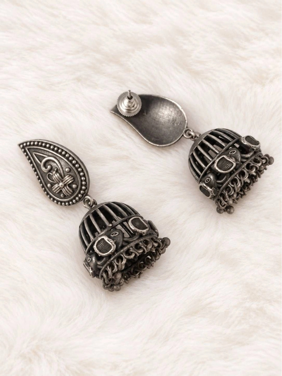 Back view of oxidised silver jhumka earrings showing butterfly push-back closure and dome detail