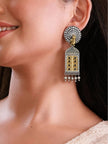 Model wearing oxidised silver dual-tone jhumka earring showing full length drop against neck and white outfit