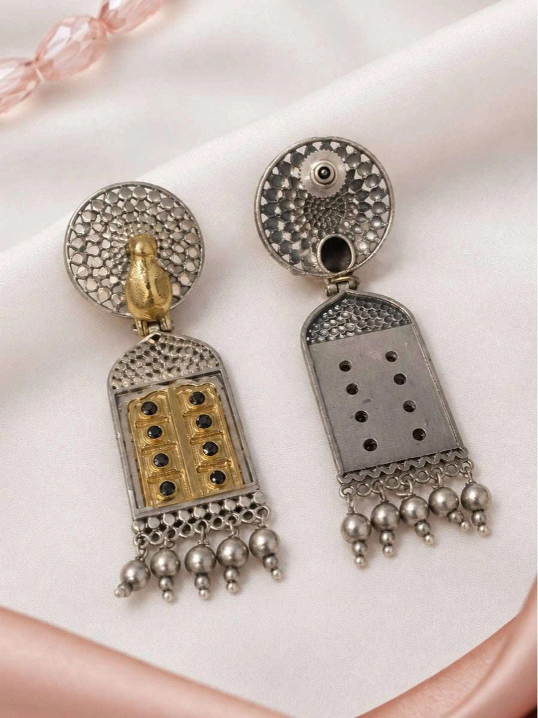 Back view of both jhumka earrings showing push-back stud fitting and plain reverse side of pendant