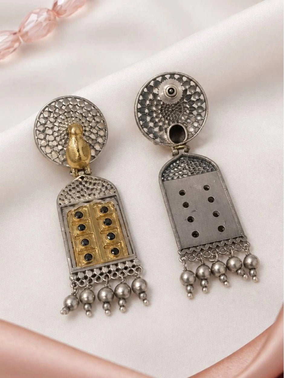 Back view of both jhumka earrings showing push-back stud fitting and plain reverse side of pendant