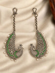 Pair of oxidised silver peacock ear cuffs with green enamel and white pearl drops laid flat on cream fabric
