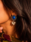 Oxidised silver blue stone stud with faux pearl drop cluster worn on a woman's ear