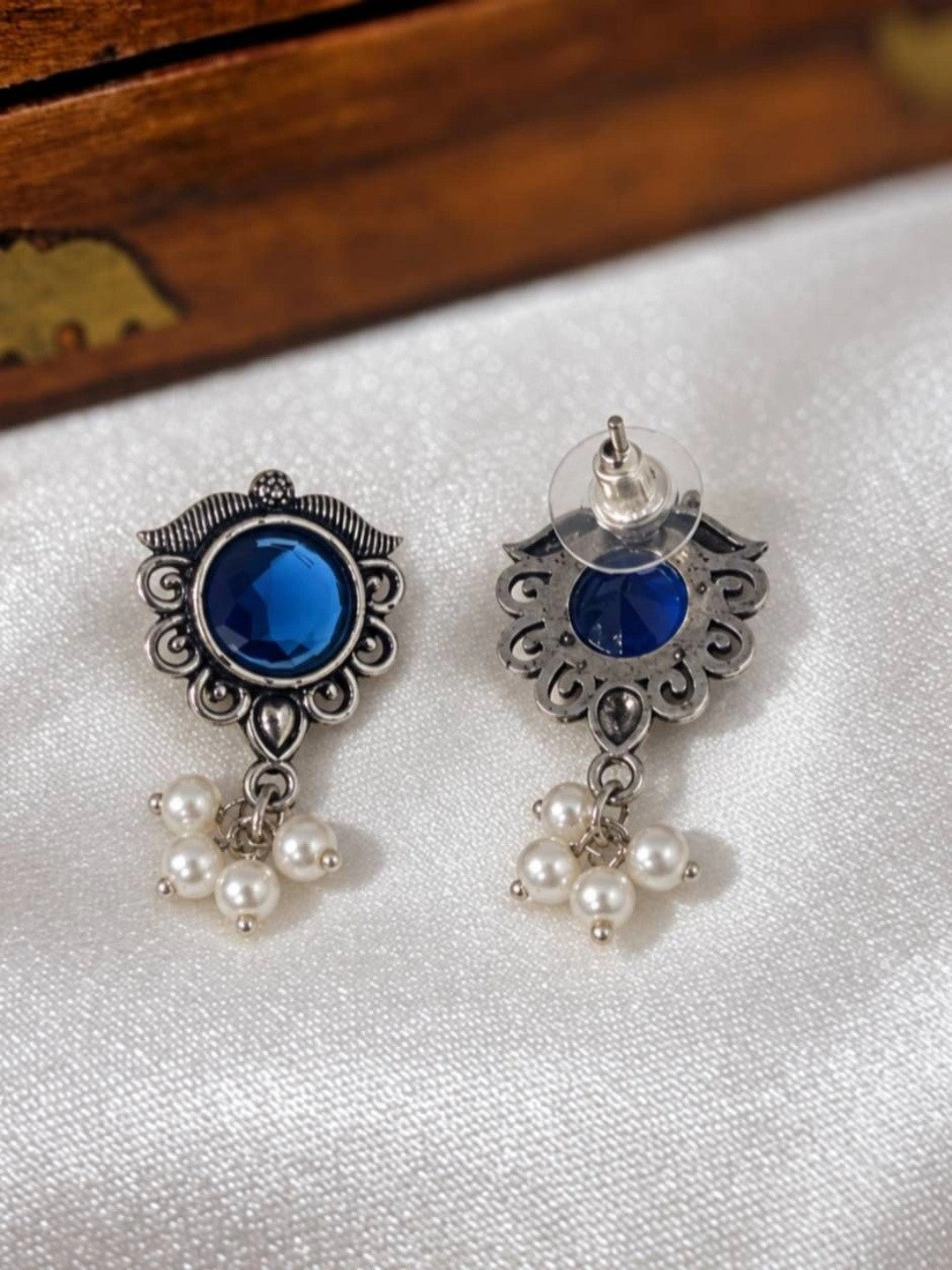 Front and back view of oxidised silver blue stone stud earrings showing push-back fastening