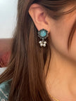 Oxidised silver stud earring with aqua stone and pearl drops worn on a woman's ear