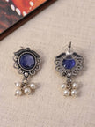 Front and back view of oxidised silver blue stone stud earrings showing push-back butterfly clutch