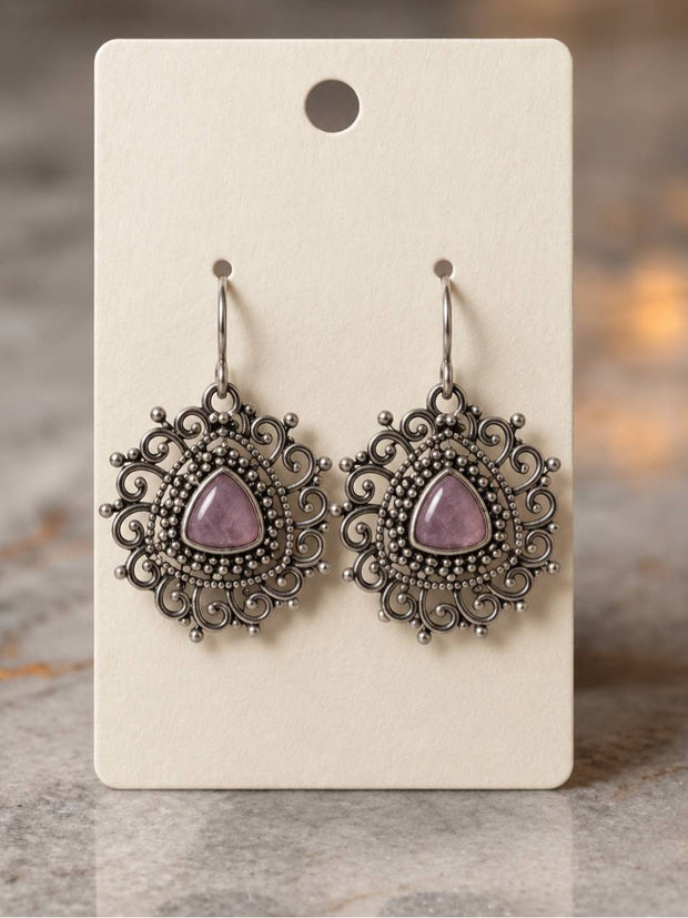 Pair of oxidised silver filigree drop earrings with pink triangular stone on cream display card