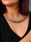 Woman wearing oxidised silver engraved choker necklace over a black v-neck top
