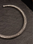 Close-up of hand-engraved floral motifs on oxidised silver brass choker necklace end terminal
