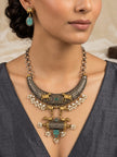 Model wearing oxidised silver choker necklace and matching Nandi bull drop earrings with a grey ethnic top