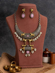 Oxidised gold-tone Nandi necklace set displayed on a brown jewellery bust with matching drop earrings and small brass bowls in the foreground