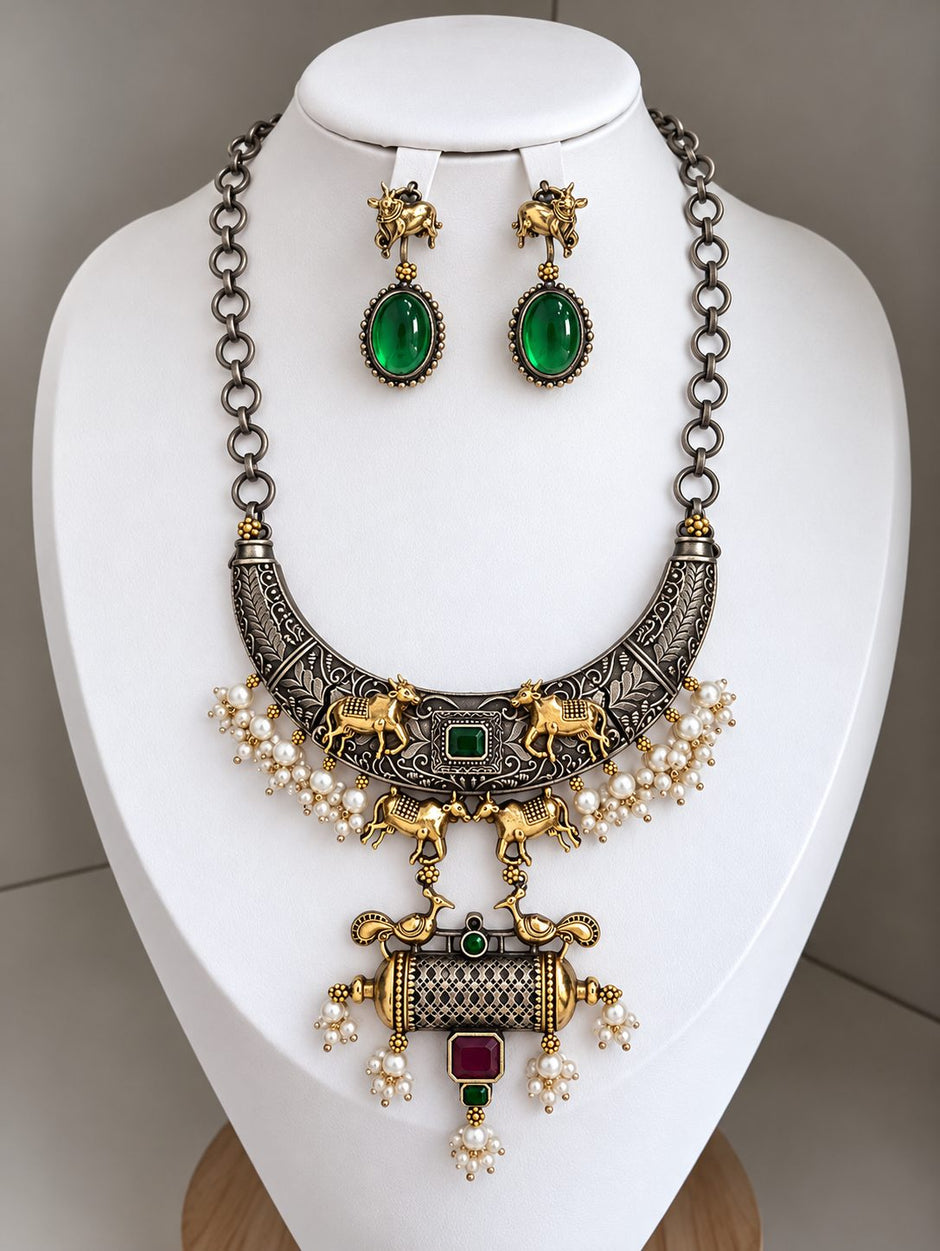 Dual tone oxidised hasli necklace set displayed on a white jewellery bust showing full pendant detail