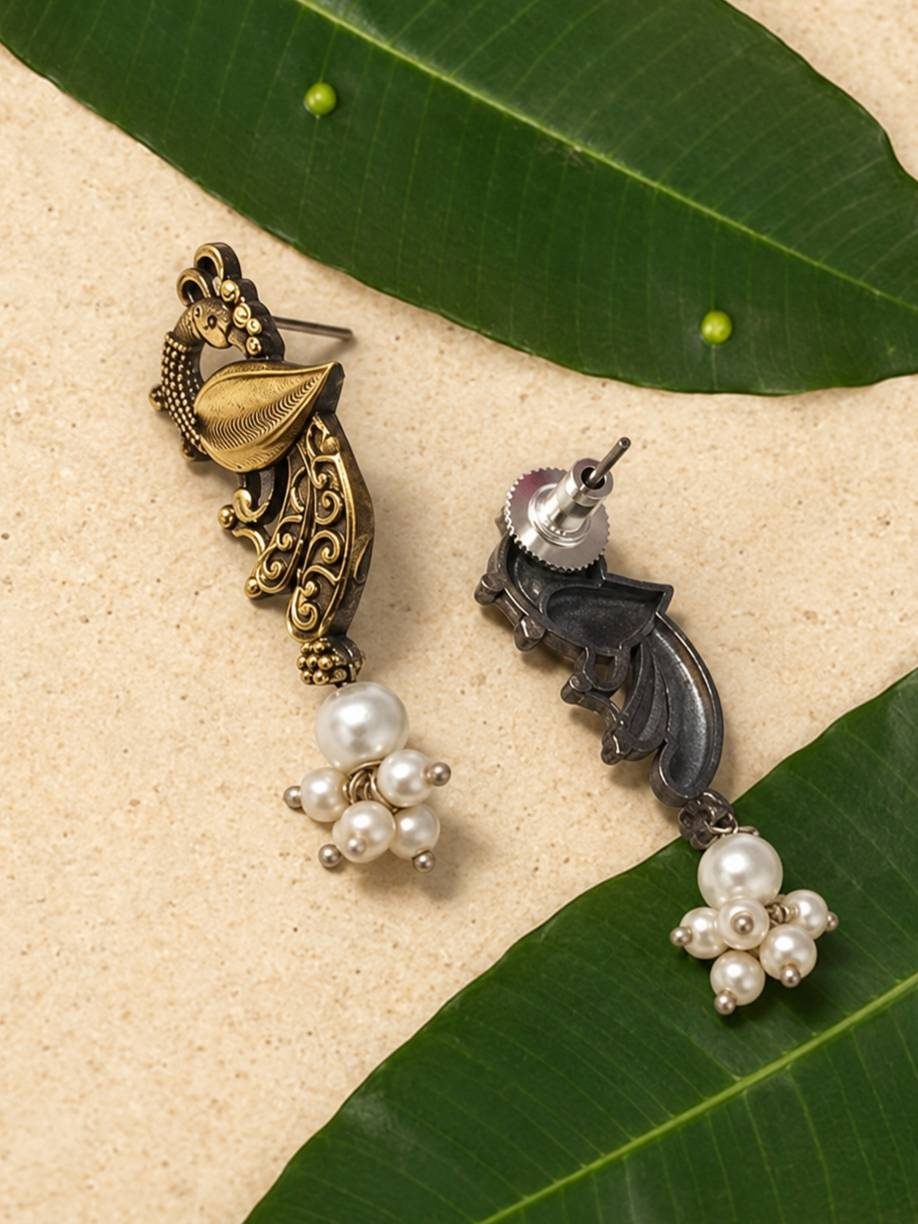 Front and back view of oxidised peacock drop earrings with faux pearl cluster on mango leaves