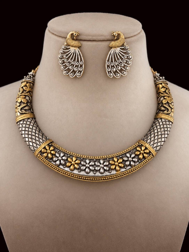 Dual-tone oxidised choker necklace with peacock stud earrings displayed on a jewellery bust against dark background