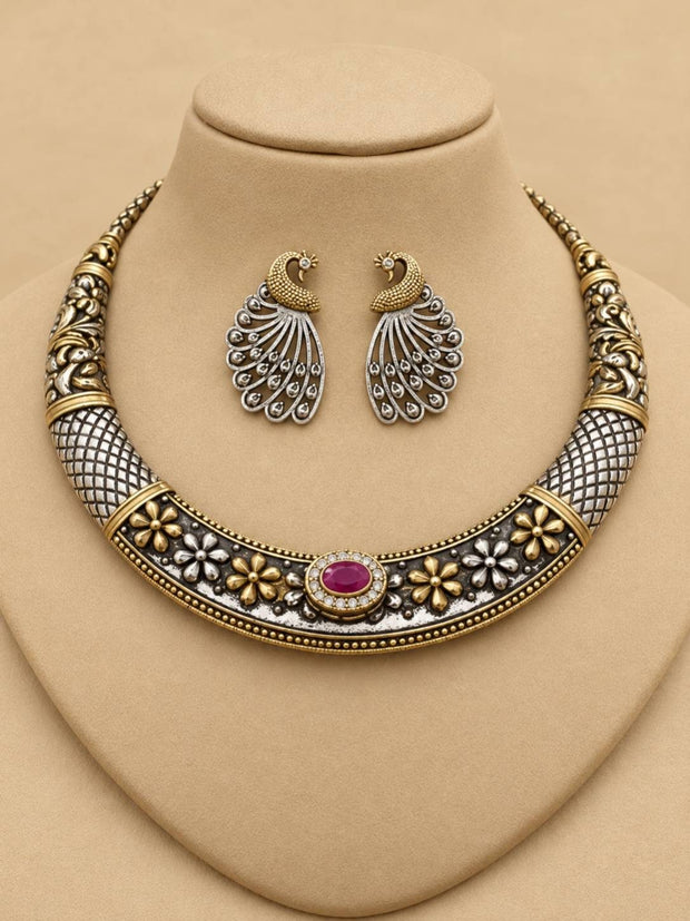 Oxidised dual-tone choker necklace and peacock stud earrings displayed on a cream jewellery bust