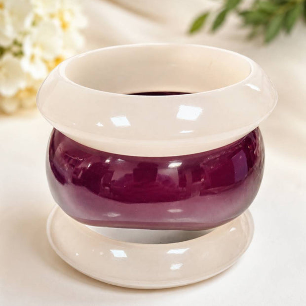 Three resin bangles stacked vertically on a display stand, showing white and deep burgundy glossy finish
