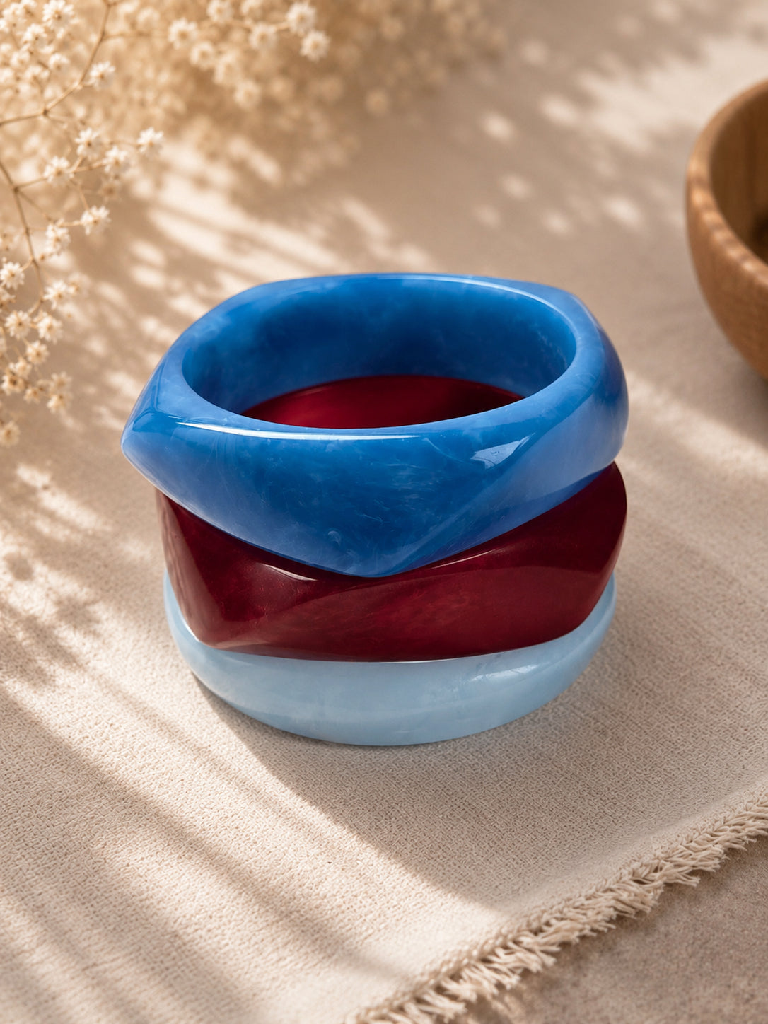 Three marble resin bangles stacked on top of each other showing the faceted angular shape from above
