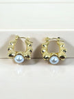 Pair of gold-plated sculpted hoop earrings with white faux pearl drop, displayed on white surface