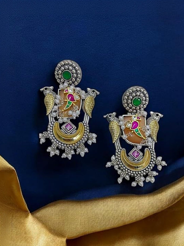 Pair of parrot chandbali earrings on a blue and gold fabric background showing both pieces