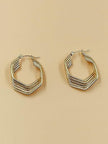 Two gold-tone angular hoop earrings with multi-row ridged design displayed on a beige background