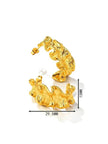 Pair of gold-plated ruffled hoop earrings placed on soft cream satin fabric