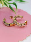 Close-up of gold-plated baguette cubic zirconia hoop earrings showing push-back stud fastening