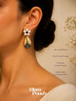 Model wearing one gold-plated floral drop earring showing scale and fit against neck and ear