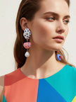 Model wearing multicolour quirky drop earrings with a colour-block dress showing full length drop and playful charm arrangement