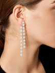 Model wearing one long silver CZ teardrop earring shown from the side profile