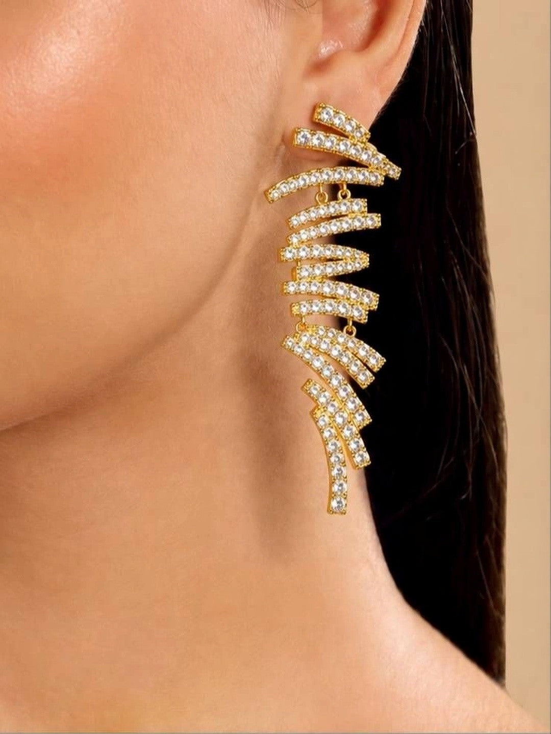 Gold-plated crystal bar drop earring worn on a woman's ear showing full length and scale