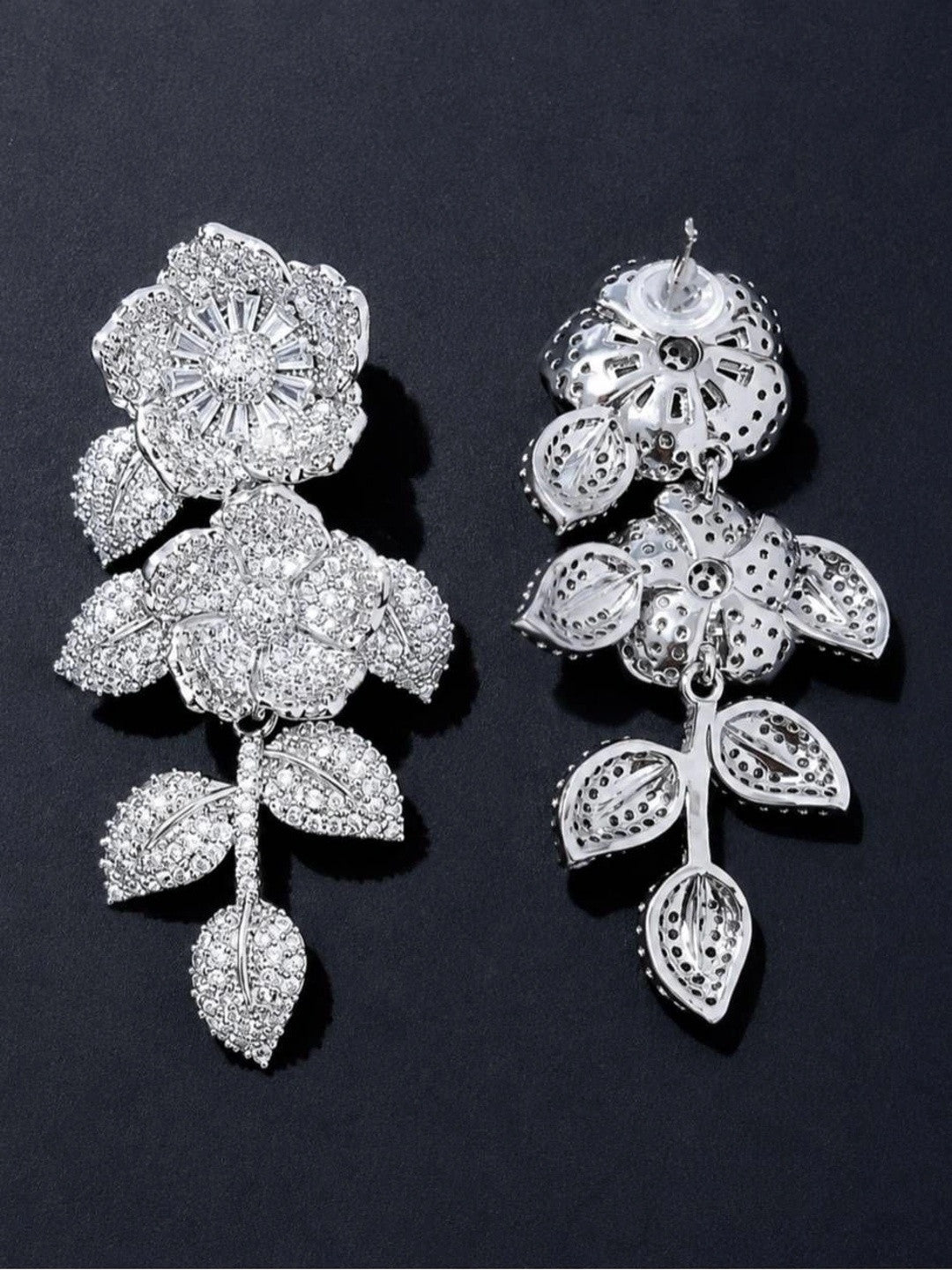 Front and back view of one silver CZ floral drop earring showing filigree reverse and stud post