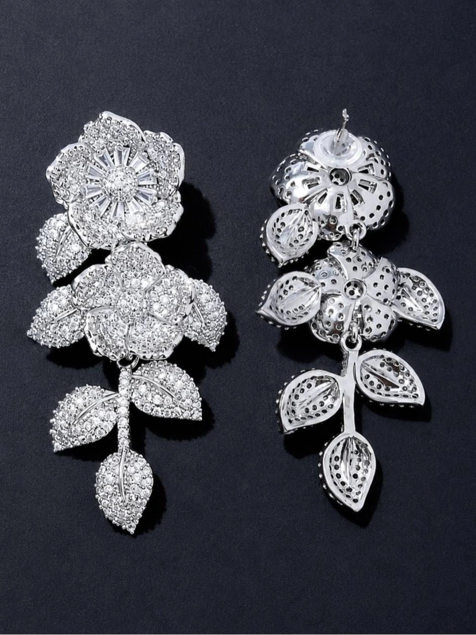 Front and back view of one silver CZ floral drop earring showing filigree reverse and stud post
